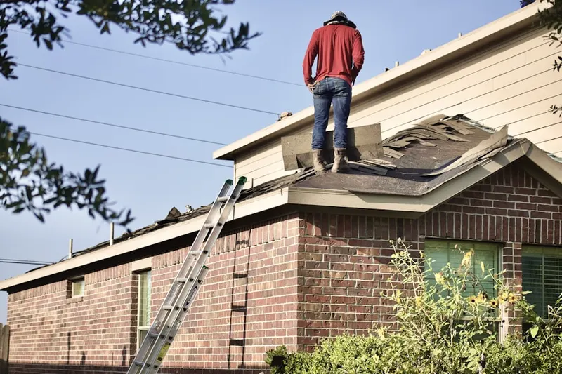Professional roofer working on a residential roof in Merion Station
